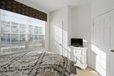 a bedroom with a bed and a window at 2563 Maneshaw in Orlando