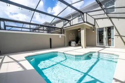 a swimming pool in the middle of a house at Wonderfull home near Disney & FREE Waterpark 2421 in Kissimmee
