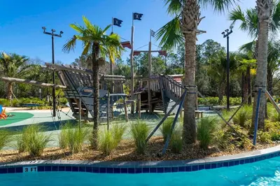 a playground at a resort with palm trees at Wonderfull home near Disney & FREE Waterpark 2421 in Kissimmee