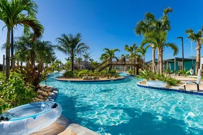 a pool at a resort with palm trees at Amazing Disney resort style & FREE Waterpark 2481 in Kissimmee