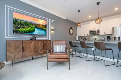 a living room with a large painting on the wall at Amazing Disney resort style & FREE Waterpark 2481 in Kissimmee
