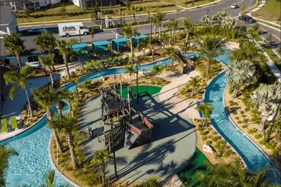 an aerial view of a water park with palm trees at Disney adventure resort style free waterpark2633 in Kissimmee