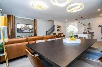 a dining room with a table and a couch at Luxury 5BR Storey Lake Retreat Near Disney 2969 in Kissimmee