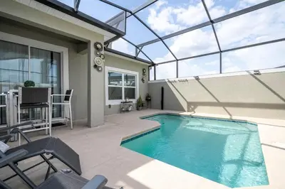 a swimming pool in a house with a glass ceiling at Luxury 5BR Storey Lake Retreat Near Disney 2969 in Kissimmee