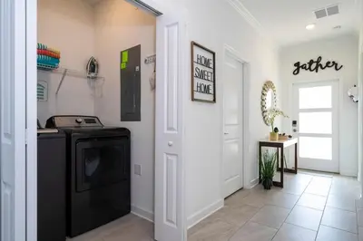 a laundry room with a washer and dryer in it at Luxury 5BR Storey Lake Retreat Near Disney 2969 in Kissimmee