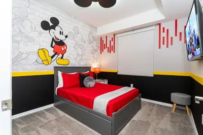 a bedroom with a mickey mouse mural on the wall at 3BR Resort Condo FREE Waterpark 3150 in Kissimmee