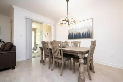 a dining room with a wooden table and chairs at Lake view & Free Resort Access near Disney 4399 in Kissimmee