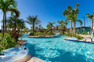 a pool at a resort with palm trees at Lake view & Free Resort Access near Disney 4399 in Kissimmee