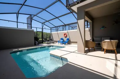 an indoor swimming pool with a glass roof at Stylish home Near Disney Free Waterpark 4407 in Kissimmee