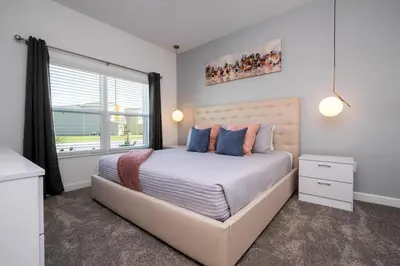a bedroom with a large bed with a large window at Stylish home Near Disney Free Waterpark 4407 in Kissimmee