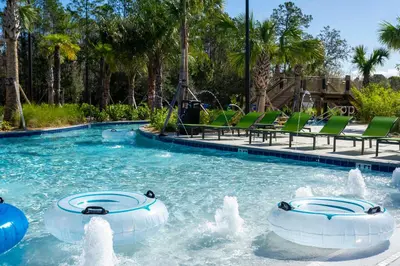a swimming pool with two water fountains in a resort at Cozy home Near Disney Free resort Access 4463 in Kissimmee