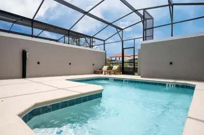 an indoor swimming pool with a glass roof at Pro decor Disney Resort style FREE Waterpark 4467 in Kissimmee