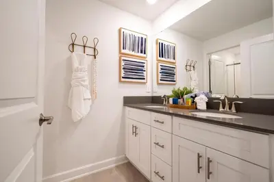 a bathroom with a sink and a mirror at Pro decor Disney Resort style FREE Waterpark 4467 in Kissimmee