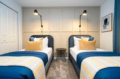 two beds sitting next to each other in a room at Pro decor Disney Resort style FREE Waterpark 4467 in Kissimmee