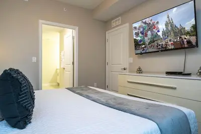 a bedroom with a bed and a flat screen tv at Resort Condo Near Disney FREE Waterpark 4721 in Kissimmee