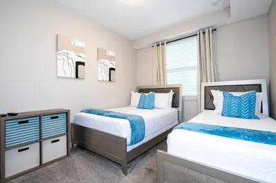 a bedroom with two beds and a dresser at Resort Condo Near Disney FREE Waterpark 4721 in Kissimmee