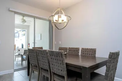 a dining room with a wooden table and chairs at Gorgeus HOUSE Near Disney & FREE water park 4963 in Kissimmee