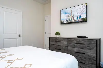 a bedroom with a bed and a tv on a wall at Gorgeus HOUSE Near Disney & FREE water park 4963 in Kissimmee