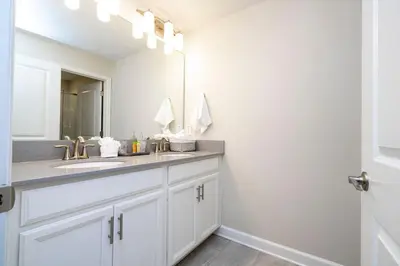 a bathroom with a sink and a mirror at Gorgeus HOUSE Near Disney & FREE water park 4963 in Kissimmee