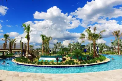 a pool at a resort with palm trees at Gorgeus HOUSE Near Disney & FREE water park 4963 in Kissimmee