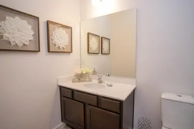 a bathroom with a sink and a mirror at Gorgeous Vacation Home near Everywhere in Kissimmee