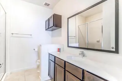 a bathroom with a sink and a mirror at Private Spa Townhome at Regal Oaks Resort in Orlando