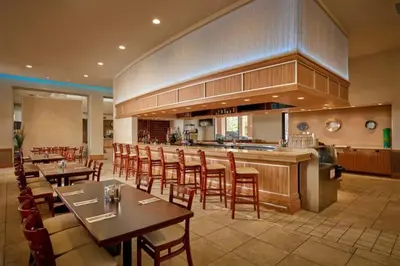 a restaurant with tables and chairs and a bar at Private Spa Townhome at Regal Oaks Resort in Orlando