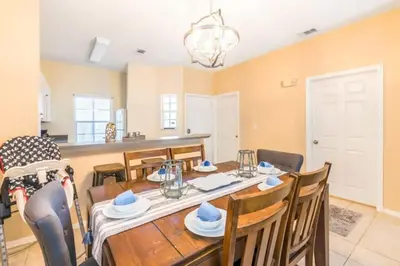 a dining room and kitchen with a table and chairs at Townhome at Emerald Island Resort in Kissimmee