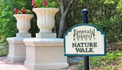 a sign in front of two vases on a wall at Townhome at Emerald Island Resort in Kissimmee