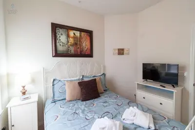 a bedroom with a bed and a tv on a wall at Townhome at Oakwater Resort in Orlando