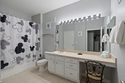 a bathroom with a sink and a toilet and a shower curtain at 7671 Comrow Unit 205 in Kissimmee