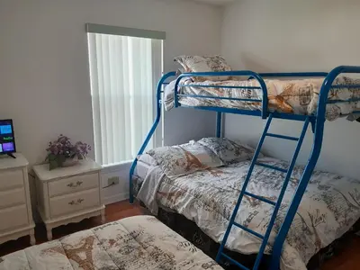 a bedroom with two bunk beds and a window at Three-Bedroom House in Clear Creek in Orlando