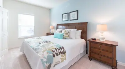 a bedroom with a large bed and a nightstand at Townhome at West Lucaya Resort 3212 in Orlando
