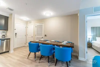 a dining room with a table and blue chairs at Apartment at Vista Cay Resort in Orlando