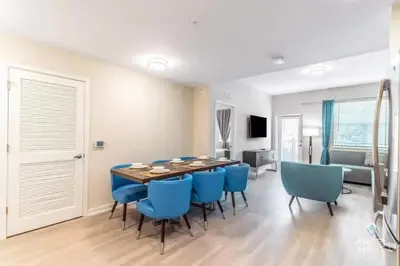 a dining room with a table and blue chairs at Apartment at Vista Cay Resort in Orlando