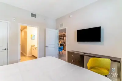 a bedroom with a bed and a television on a wall at Apartment at Vista Cay Resort in Orlando