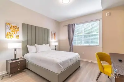 a bedroom with a bed and a desk and a window at Apartment at Vista Cay Resort in Orlando