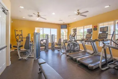 a gym with treadmills and elliptical machines at Apartment at Vista Cay Resort in Orlando