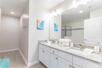 a bathroom with two sinks and a large mirror at Apartment at Vista Cay Resort in Orlando