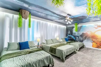 a bedroom with two beds and a painting on the wall at Private Pool and Spa Home at Storey Lake Resort in Kissimmee