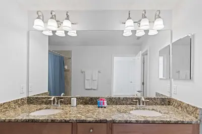 a bathroom with two sinks and a large mirror at 8960 Cat Palm Road in Kissimmee