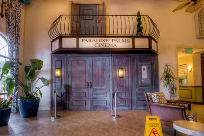 a building with a sign that reads parakeet plains cinema at 8960 Cat Palm Road in Kissimmee
