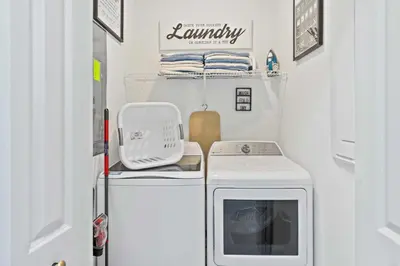 a small laundry room with a washer and dryer at 2452 Reading Trail in Kissimmee