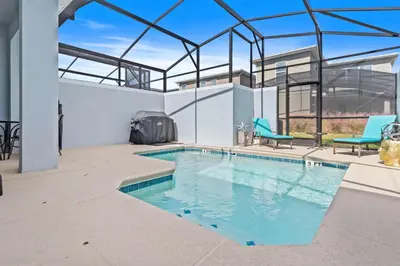 a swimming pool in a house with a glass ceiling at 2452 Reading Trail in Kissimmee
