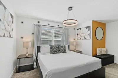 a bedroom with a white bed and a window at 2452 Reading Trail in Kissimmee