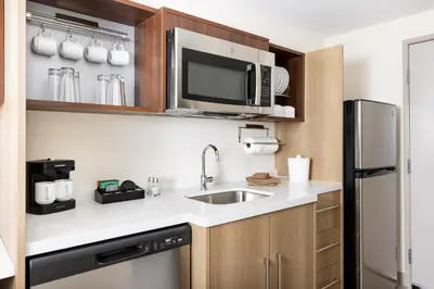 a kitchen with a sink and a microwave at Home2 Suites By Hilton Lake Mary Orlando in Lake Mary