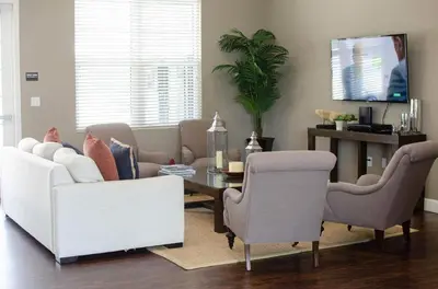 a living room with a couch and a table and chairs at New in the market townhouse in West Lucaya! in Kissimmee
