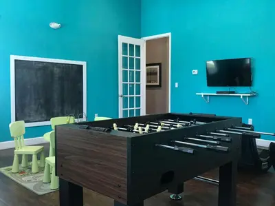 a large pool table in a room with blue walls at New in the market townhouse in West Lucaya! in Kissimmee