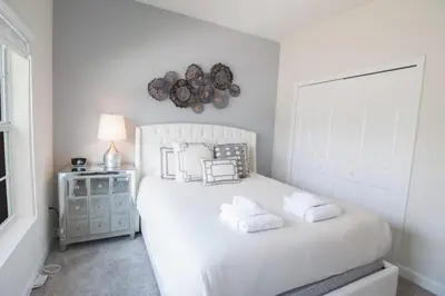 a bedroom with a white bed with two pillows at Private Pool Townhome at Storey Lake Resort in Kissimmee