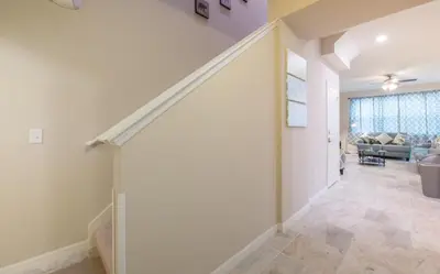 an empty hallway with a staircase in a house at Townhome at Compass Bay Community in Kissimmee